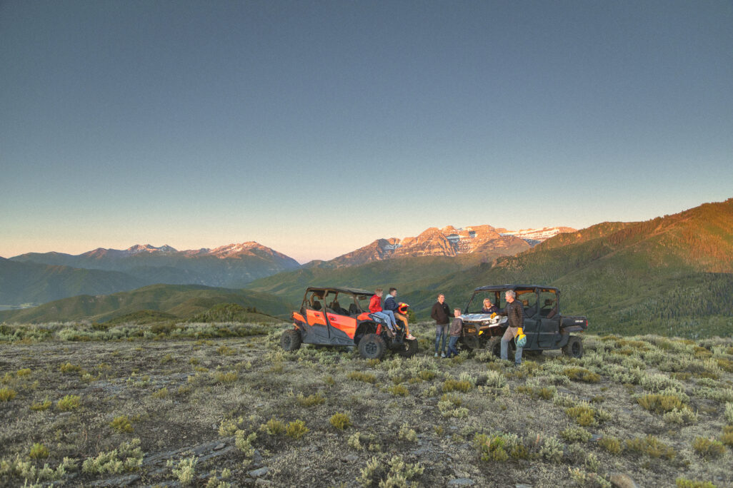 Two ATVs with people outdoors