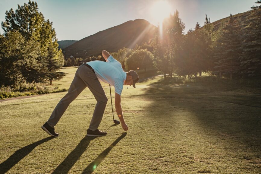 A golfer picking up the ball