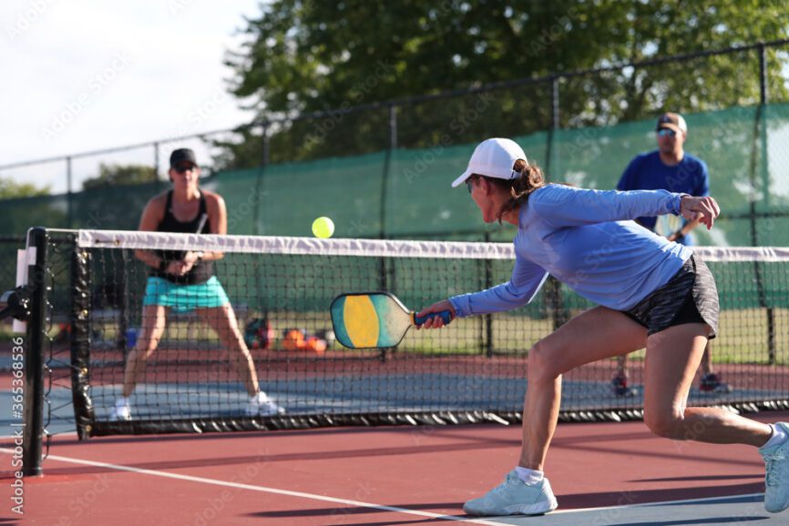 Two women playing pickleball
