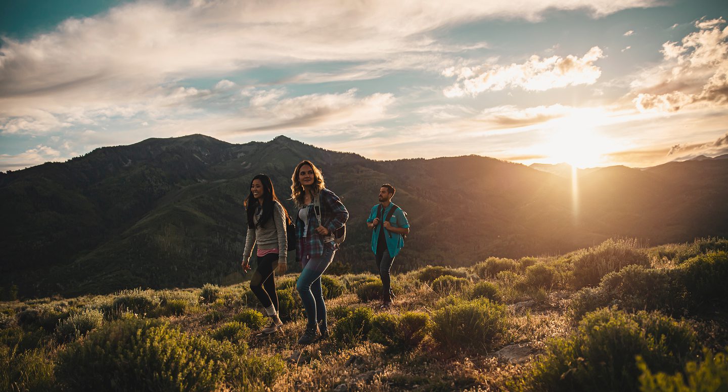 Group of people hiking in the sunset