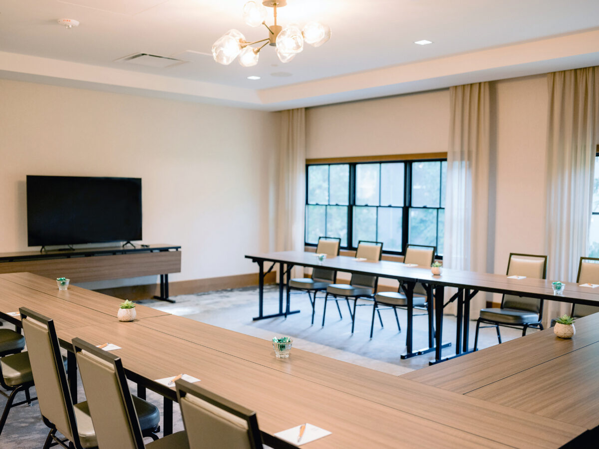 Conference room with the desk, chairs and screen