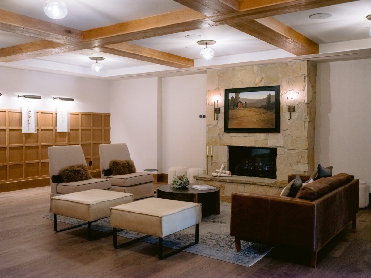 Lounge room with chairs, ottomans, fireplace