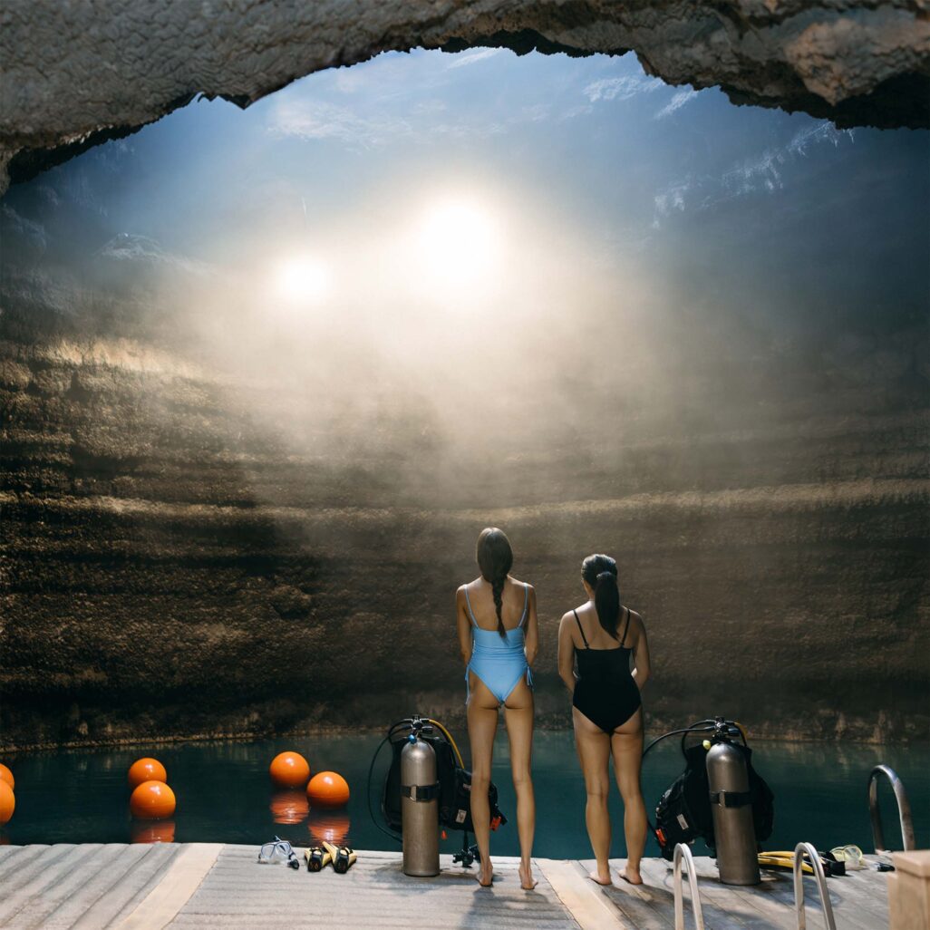 Two women preparing to scuba dive in The Crater at Homestead Midway Utah