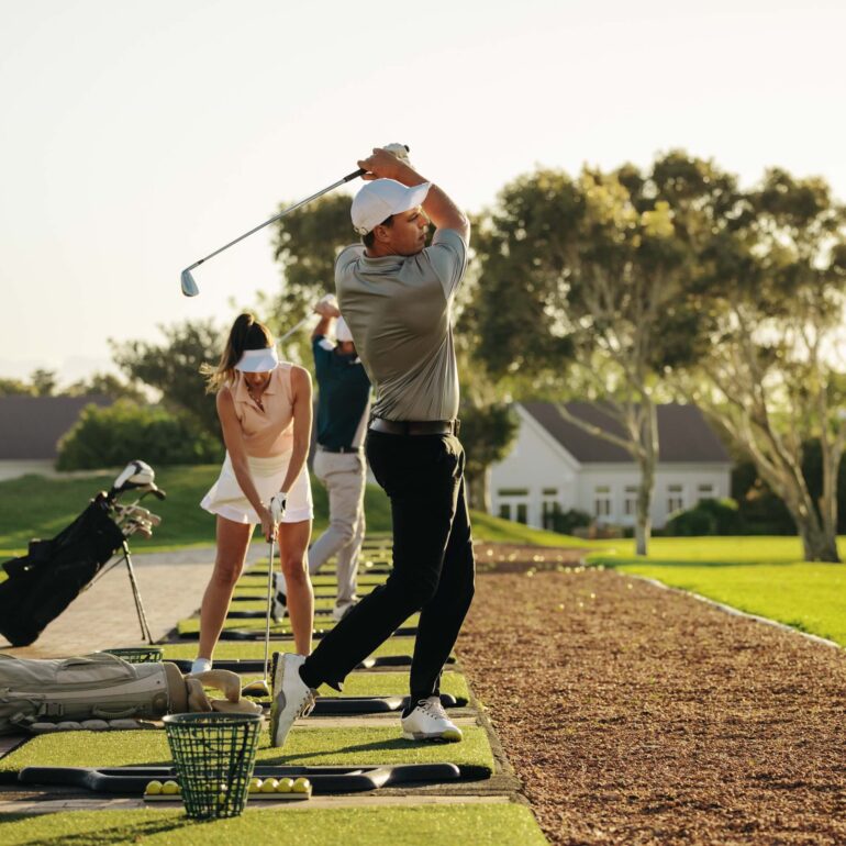 Stock image of golfers at driving range